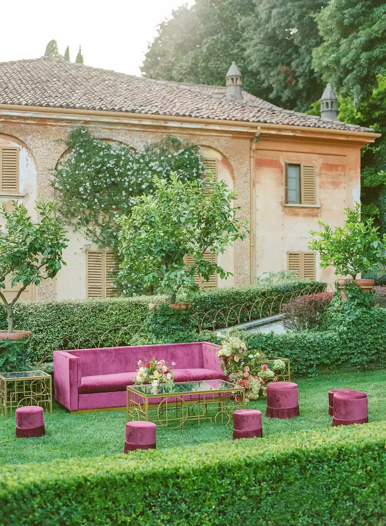 outdoor wedding lounge with fuchsia velvet couches