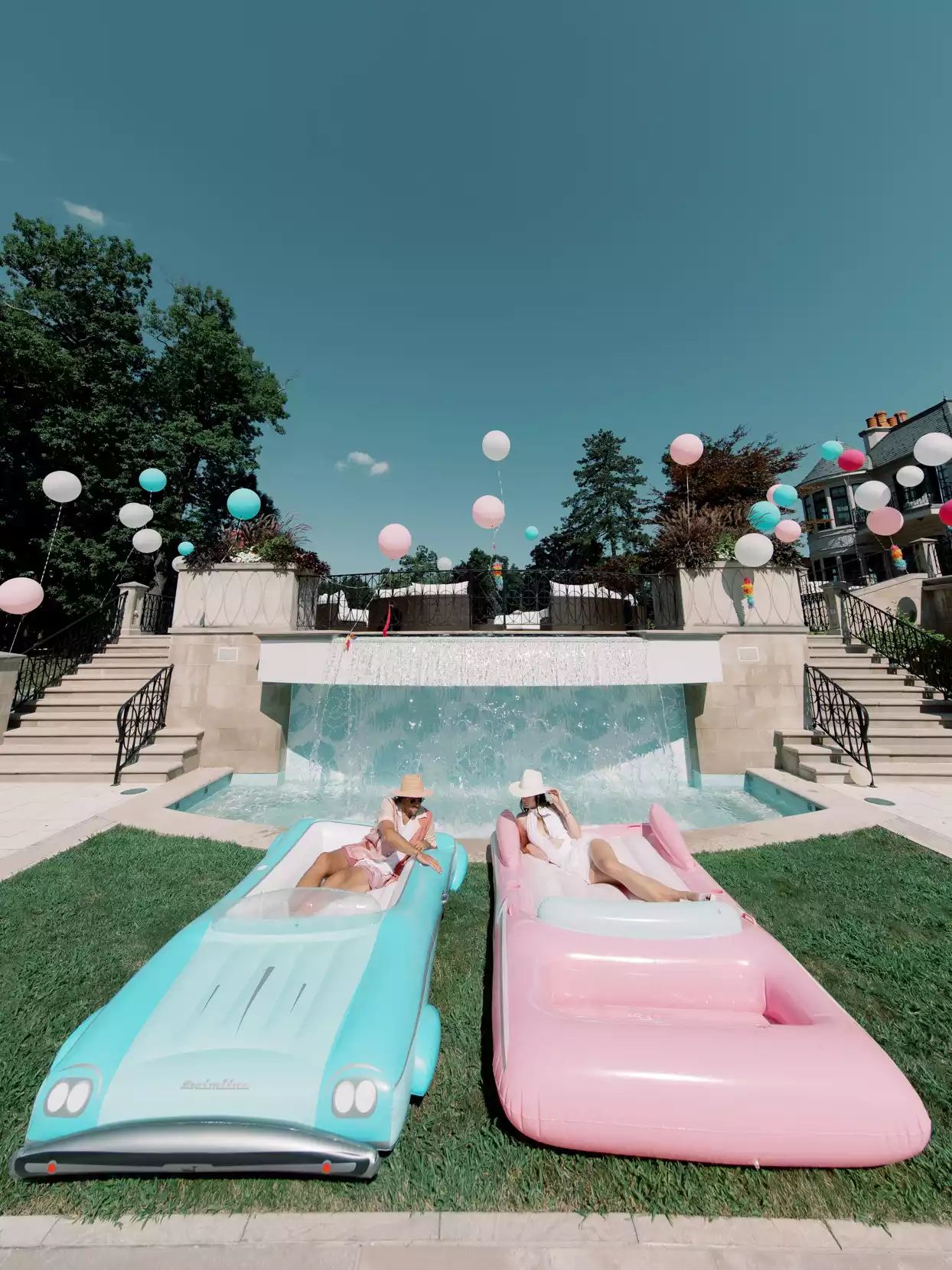 bride and groom on blue and pink pool floats
