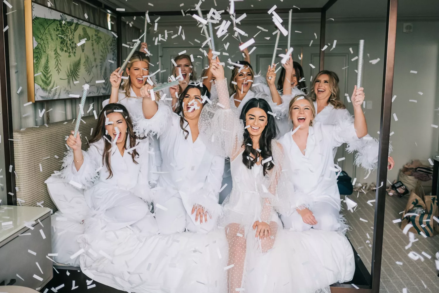 bride and bridal party popping confetti